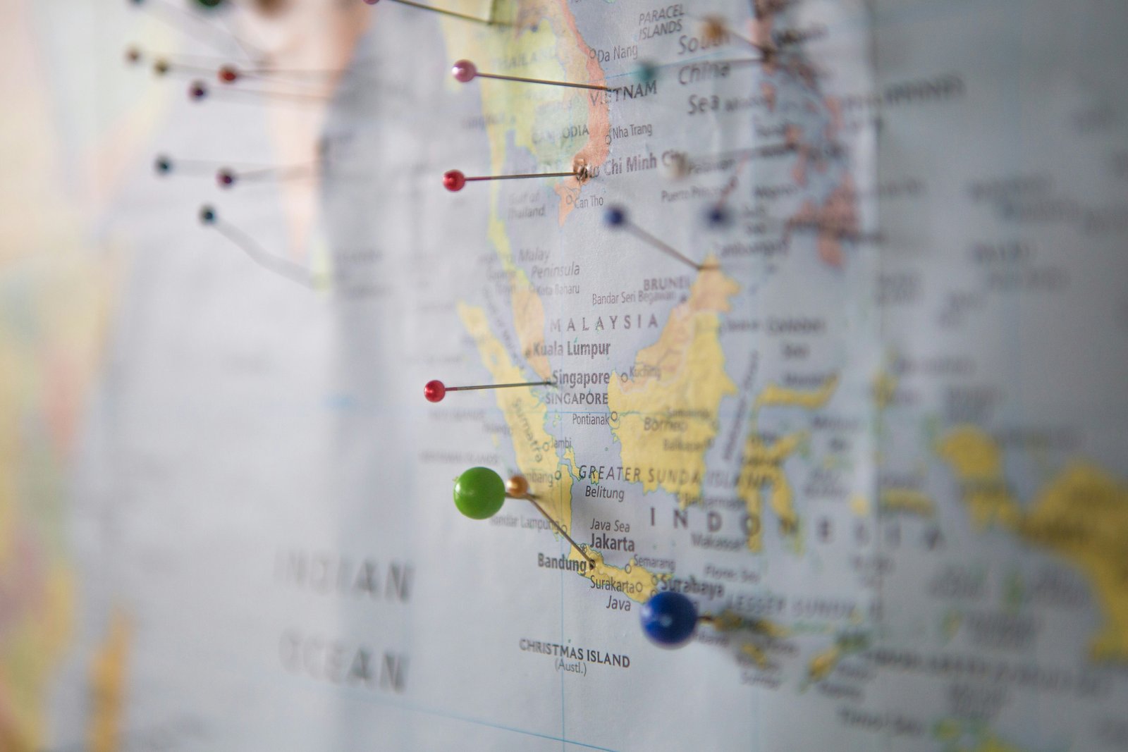 A pinned map of South-East Asia with coloured marker pins on Vietnam, Ho Chi Minh City, Singapore and Jakarta, illustrating multi-country business development planning across the region.