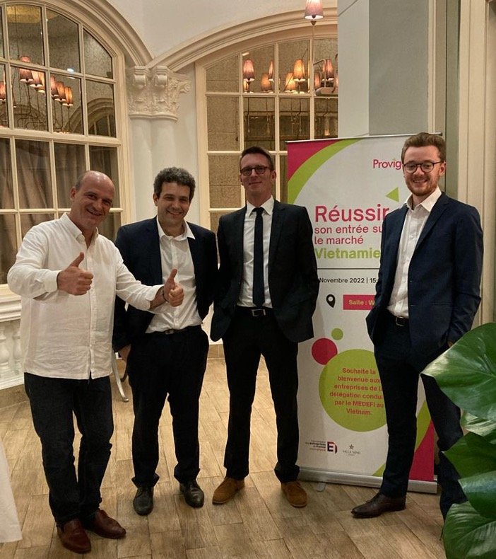Vincent Treluyer and three colleagues standing in front of a Provigood roll-up banner reading “Réussir son entrée sur le marché Vietnamien” at a MEDEF delegation event, Vietnam, November 2022.